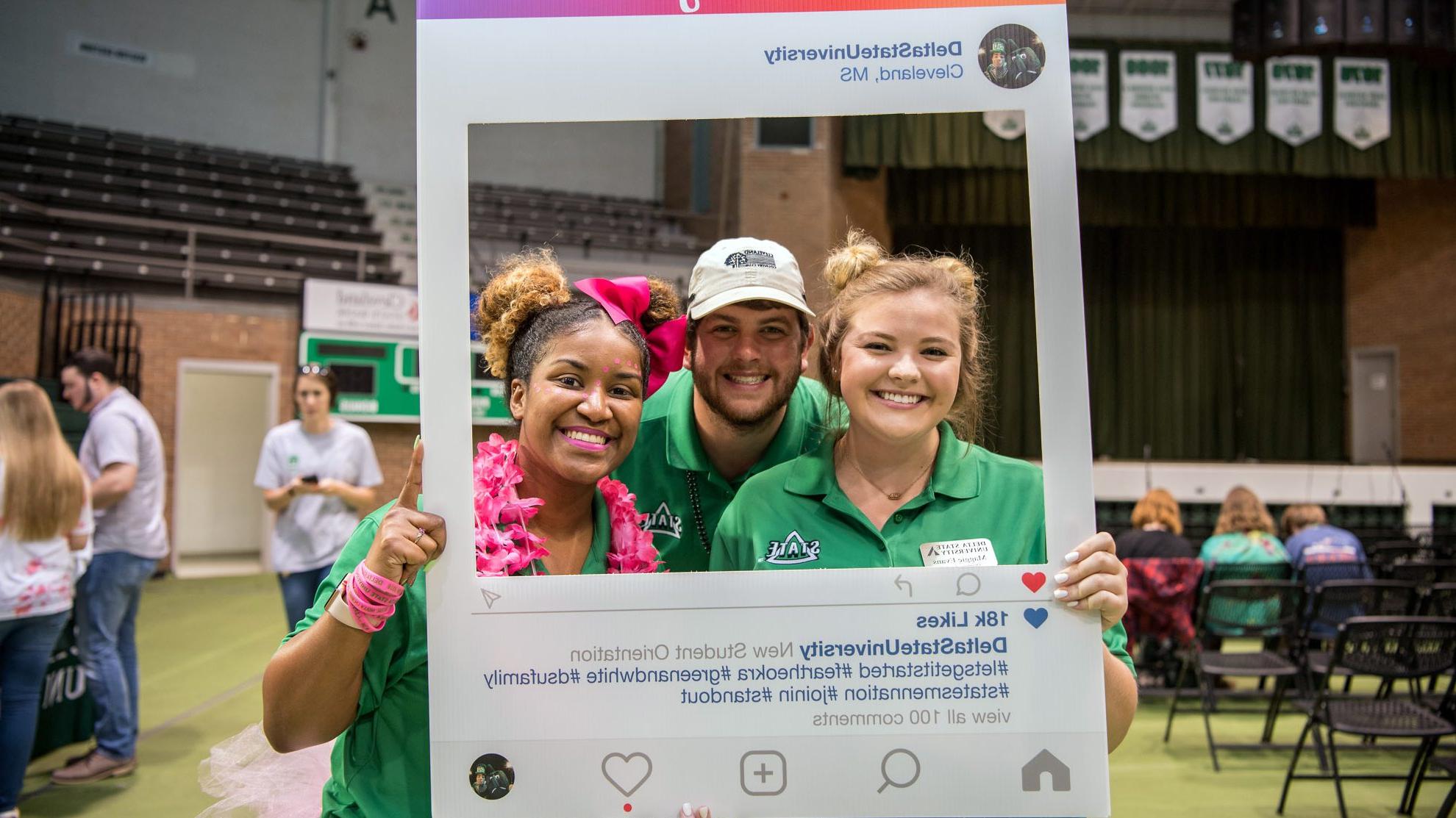 Students smiling at camera with Delta State Instagram frame.